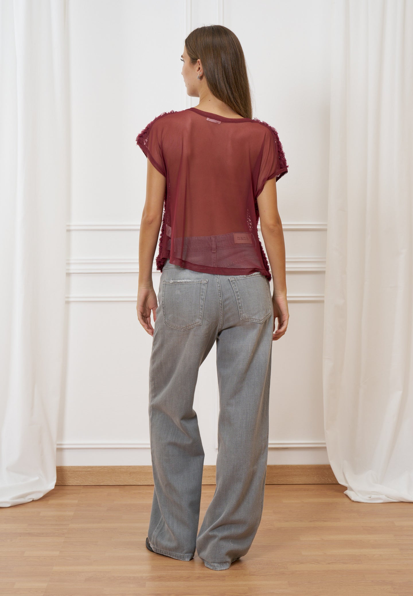 Blusa trasparente con frange