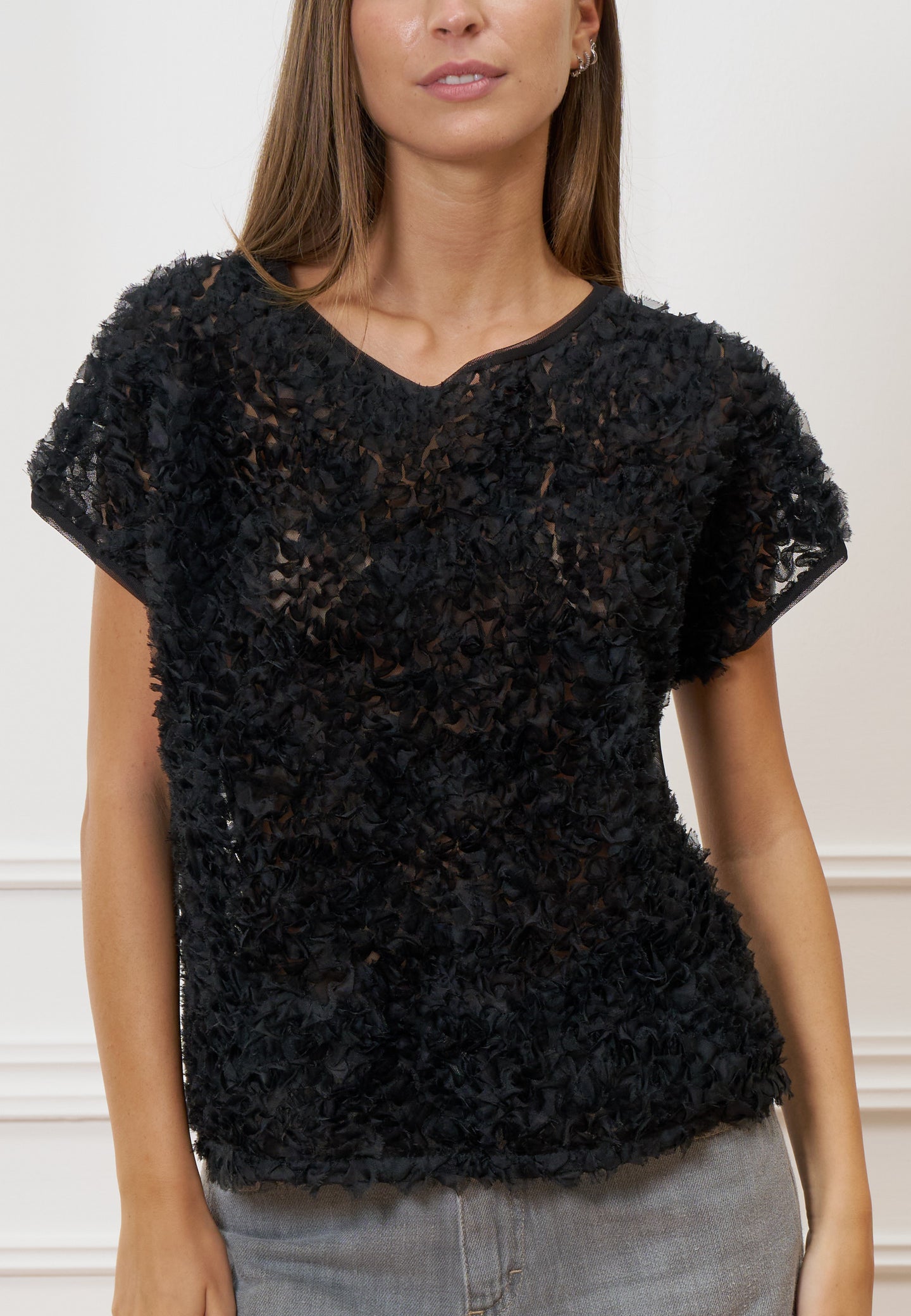 Blusa trasparente con frange