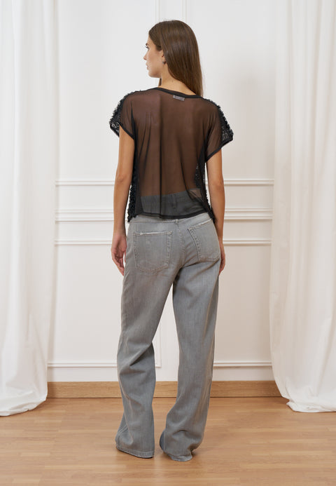 Blusa trasparente con frange