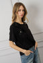 T-shirt con rouches e fiori