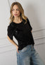 T-shirt con rouches e fiori
